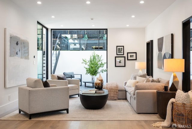 interior space featuring floor to ceiling windows, a wealth of natural light, and light hardwood / wood-style flooring