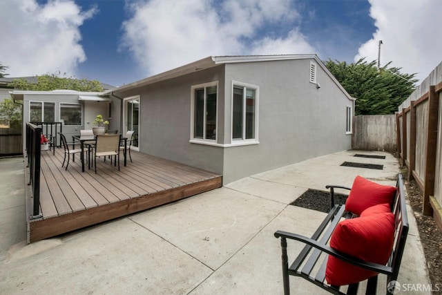 636 Edgemar Ave, Pacifica, CA 94044 - rear view of house featuring a fenced backyard, outdoor dining space, stucco siding, a deck, and a patio area