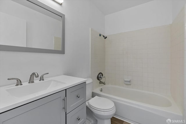 full bathroom featuring toilet, vanity, and tiled shower / bath