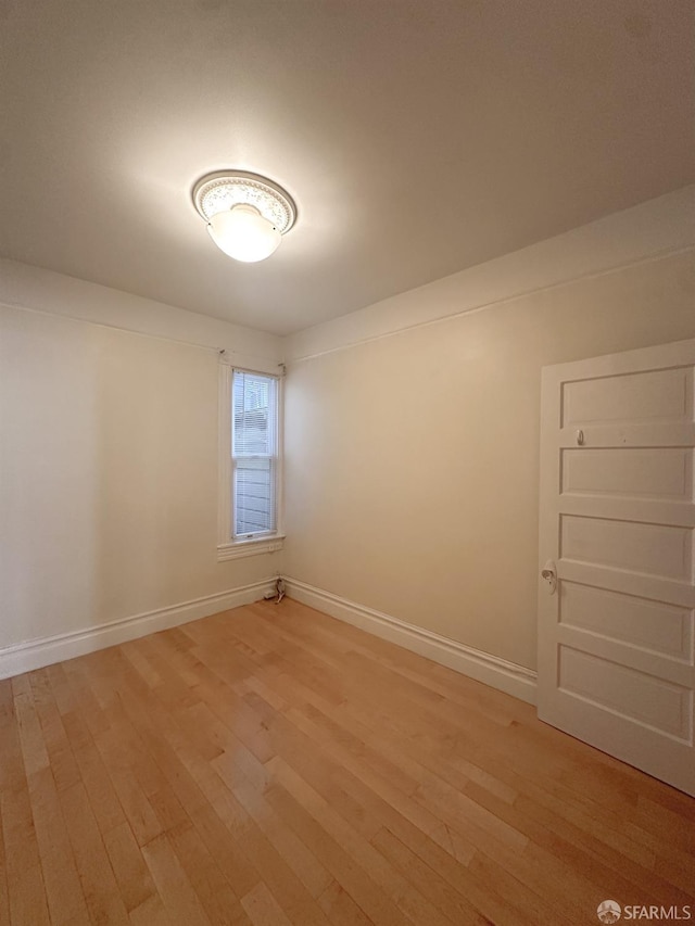 spare room with hardwood / wood-style floors