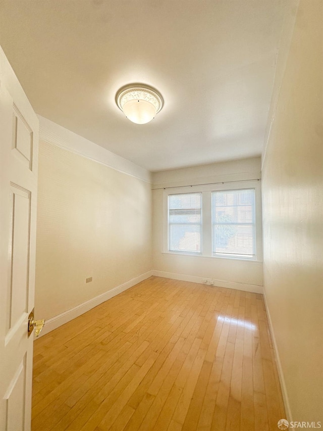 spare room with hardwood / wood-style floors