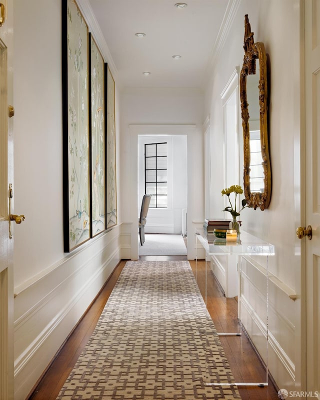 hall featuring hardwood / wood-style flooring, plenty of natural light, and crown molding