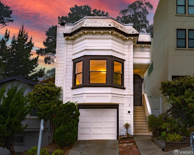 276 Bemis St, San Francisco, CA 94131 - view of front facade featuring an attached garage, stairs, driveway, and a high end roof
