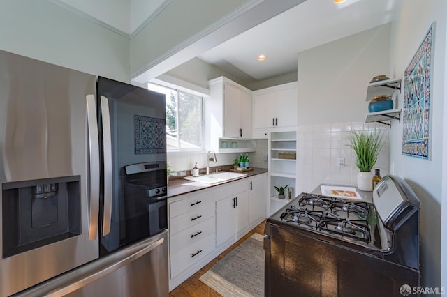 276 Bemis St, San Francisco, CA 94131 - kitchen with stainless steel fridge, black gas range oven, open shelves, decorative backsplash, and recessed lighting