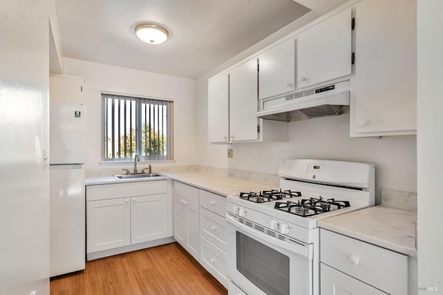 1285 Redwood Blvd Unit C, Novato, CA 94947 - kitchen with white appliances, under cabinet range hood, light wood-type flooring, light countertops, and white cabinets