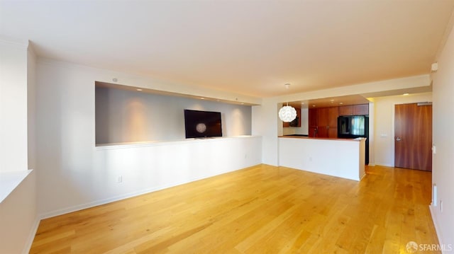 unfurnished room with light wood-type flooring