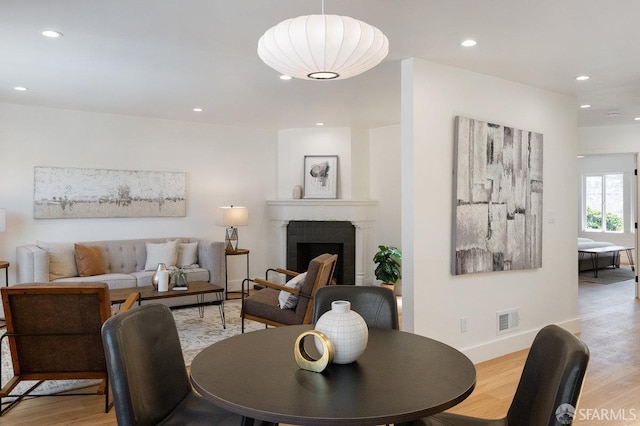 69 Lobos St, San Francisco, CA 94112 - dining area with recessed lighting, light wood finished floors, and a fireplace