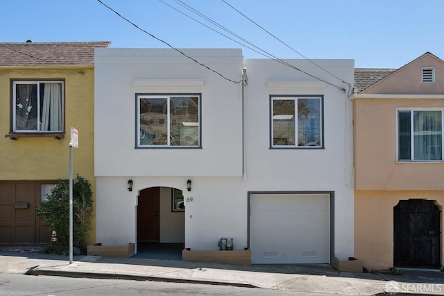 69 Lobos St, San Francisco, CA 94112 - townhome / multi-family property with stucco siding, a shingled roof, and a garage