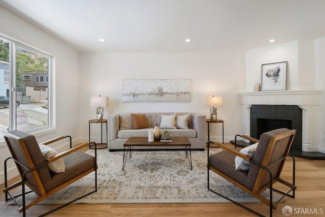 69 Lobos St, San Francisco, CA 94112 - living area with wood finished floors, a fireplace with flush hearth, and recessed lighting