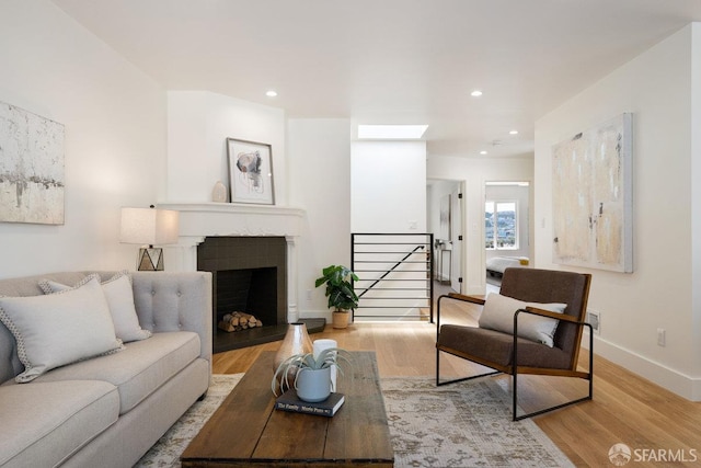 69 Lobos St, San Francisco, CA 94112 - living room featuring wood finished floors, recessed lighting, and a fireplace