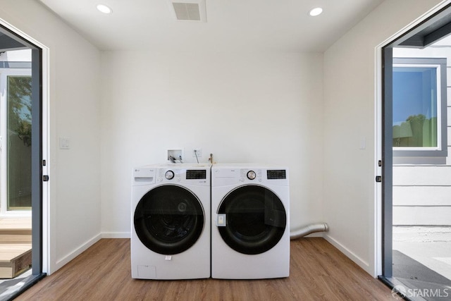 69 Lobos St, San Francisco, CA 94112 - laundry area with wood finished floors, independent washer and dryer, and recessed lighting