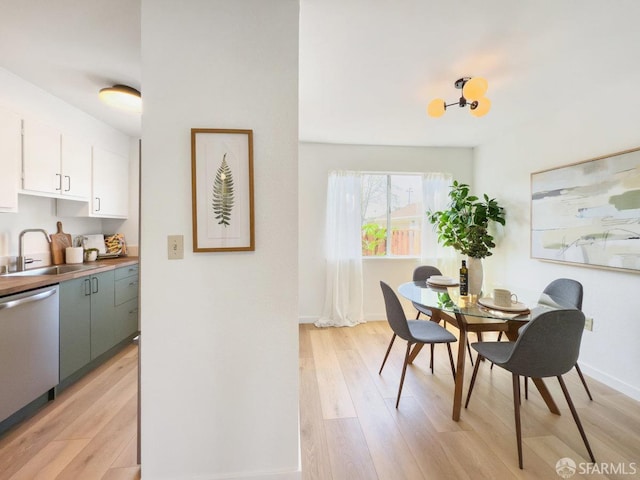 dining room featuring light wood-style floors and baseboards