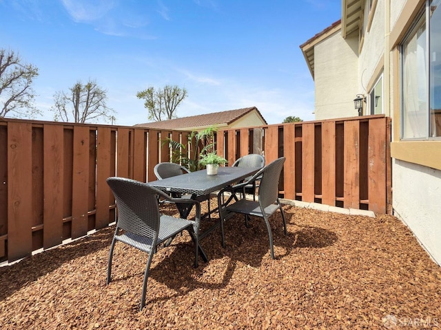 view of patio / terrace with outdoor dining area and fence