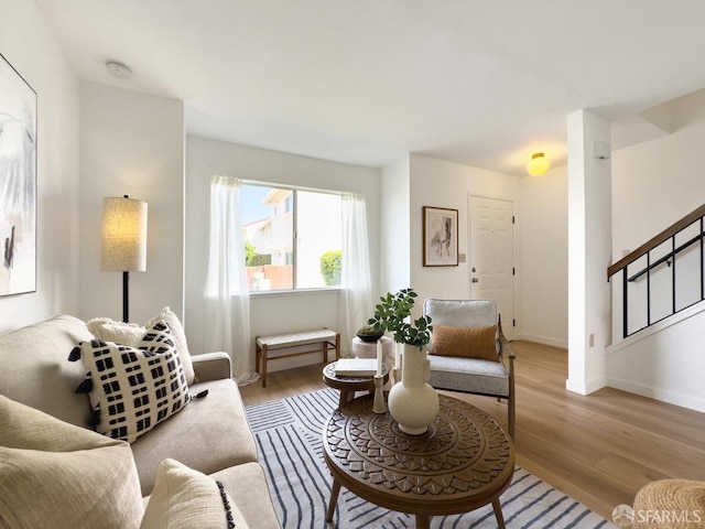 living room featuring baseboards and light wood-style floors