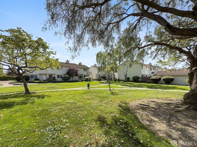 exterior space featuring fence and a front yard