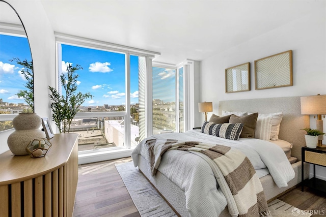 555 Fulton St Unit 519, San Francisco, CA 94102 - bedroom with wood finished floors, a wall of windows, and a view of city