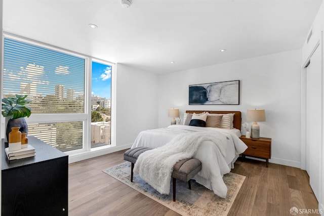 555 Fulton St Unit 519, San Francisco, CA 94102 - bedroom with light wood-style floors, baseboards, recessed lighting, and a view of city