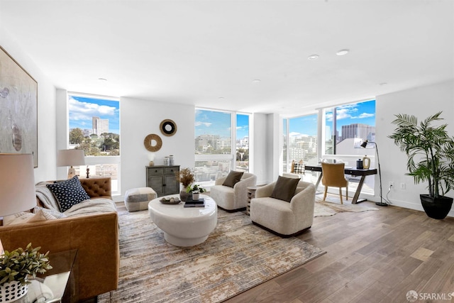 555 Fulton St Unit 519, San Francisco, CA 94102 - living area with a view of skyline, wood finished floors, a wall of windows, and baseboards
