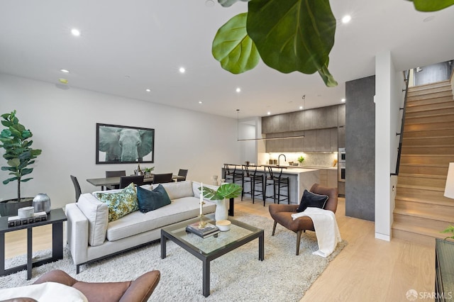 living room with sink and light hardwood / wood-style floors