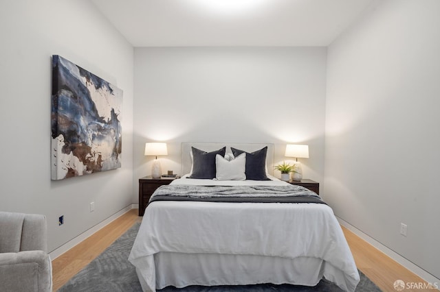 bedroom with hardwood / wood-style floors