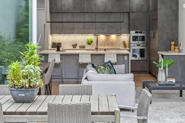 living room featuring sink and hardwood / wood-style flooring