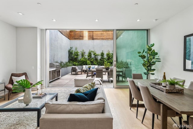 interior space with a wall of windows and light hardwood / wood-style floors