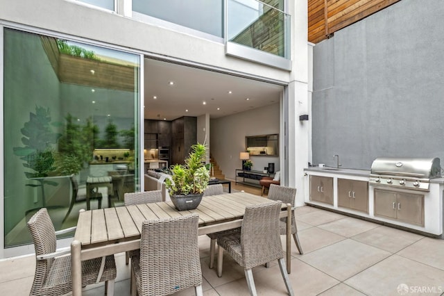 view of patio featuring exterior kitchen, sink, and grilling area