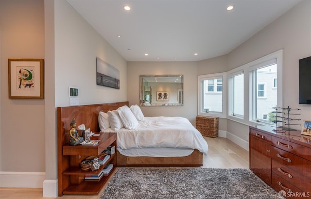 bedroom with recessed lighting, light wood-style floors, and baseboards