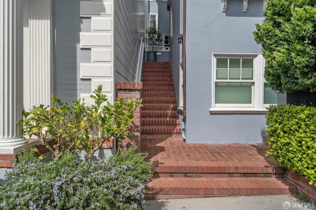 entrance to property featuring stucco siding