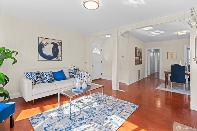 living room with decorative columns and dark hardwood / wood-style floors