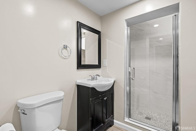 bathroom with vanity, toilet, and an enclosed shower