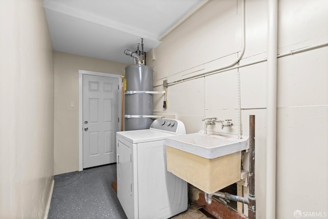 clothes washing area featuring washer / clothes dryer, sink, and strapped water heater