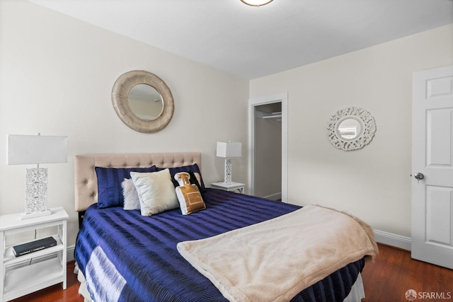 bedroom with dark hardwood / wood-style floors