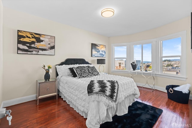 bedroom with dark wood-type flooring