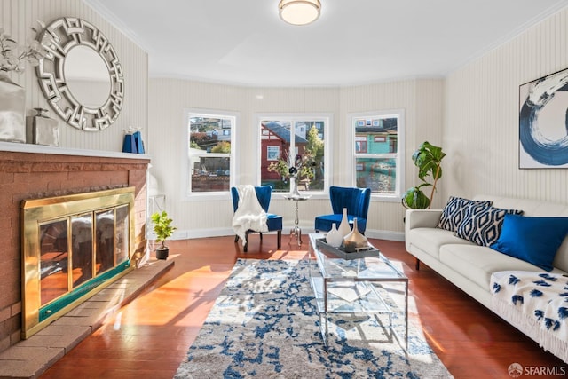 living room featuring hardwood / wood-style flooring, a fireplace, and ornamental molding