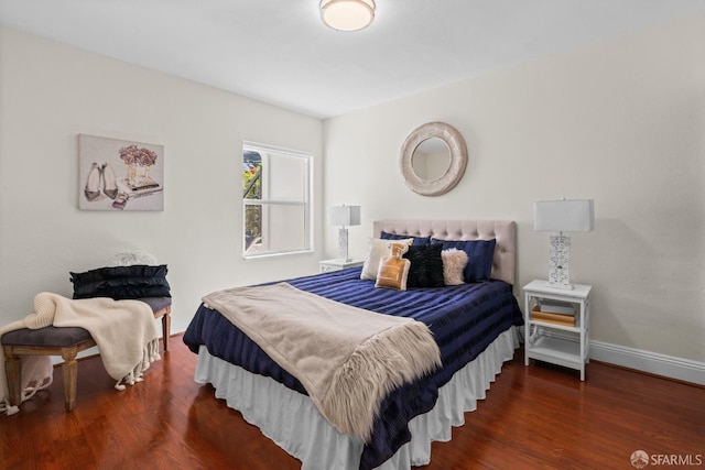 bedroom with dark hardwood / wood-style flooring