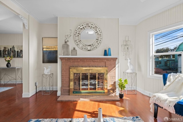 living room featuring crown molding, a fireplace, and dark hardwood / wood-style floors