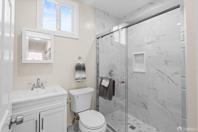 bathroom featuring walk in shower, a wealth of natural light, vanity, and toilet