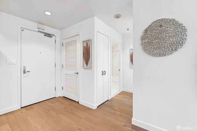 corridor with light hardwood / wood-style flooring