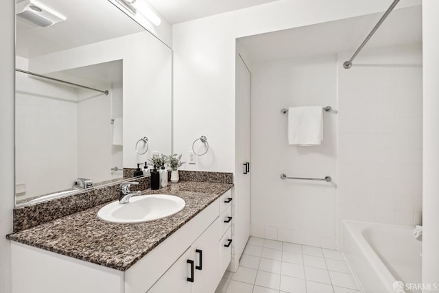 bathroom featuring vanity, bathtub / shower combination, and tile patterned flooring