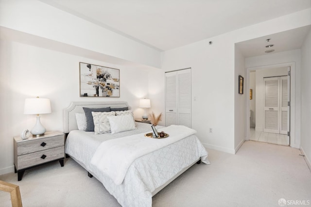 bedroom featuring light colored carpet and a closet