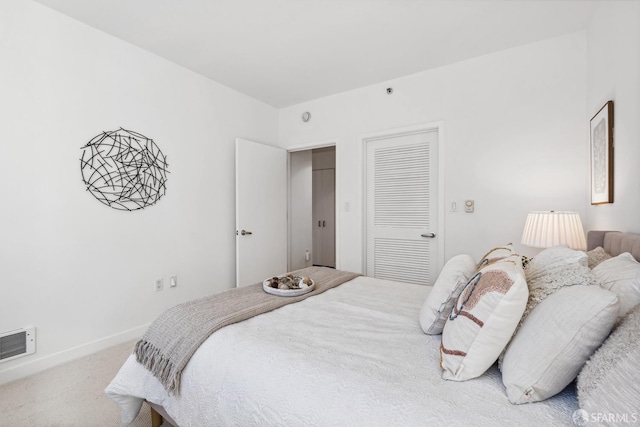 bedroom with a closet and carpet flooring