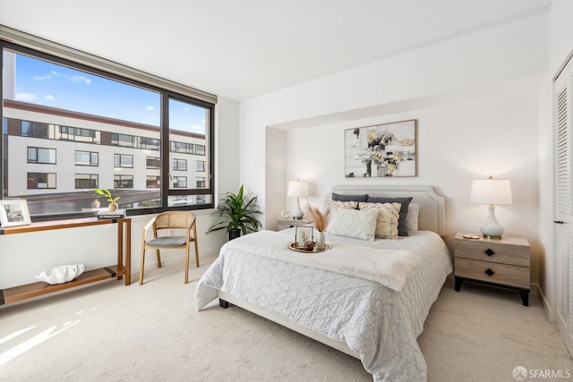 bedroom featuring light colored carpet