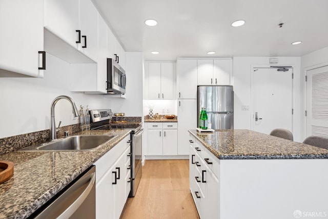 kitchen with a center island, white cabinetry, and appliances with stainless steel finishes