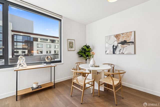 dining space with hardwood / wood-style flooring