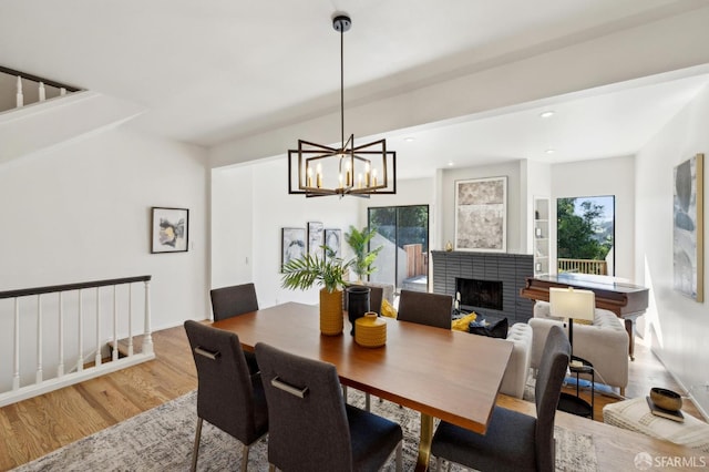 112 S Lake Merced Hls, San Francisco, CA 94132 - dining area featuring wood finished floors, a brick fireplace, a chandelier, and recessed lighting