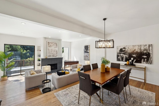 112 S Lake Merced Hls, San Francisco, CA 94132 - dining room with a chandelier, a brick fireplace, wood finished floors, and recessed lighting