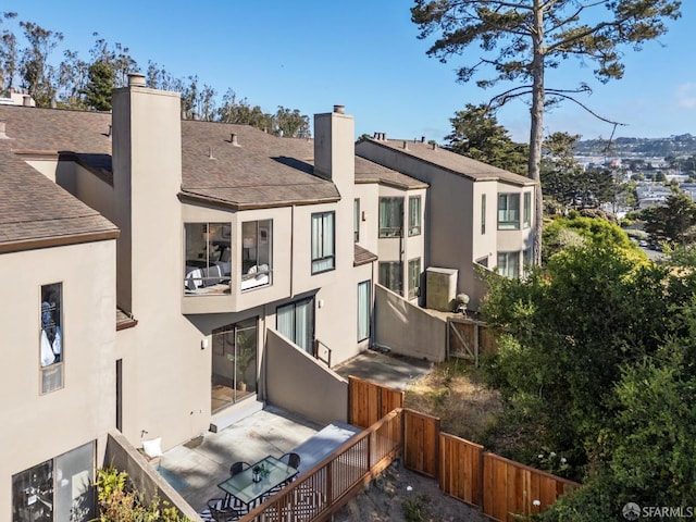 112 S Lake Merced Hls, San Francisco, CA 94132 - back of property with a chimney, stucco siding, a balcony, and a shingled roof
