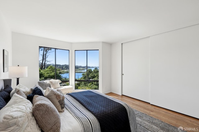 112 S Lake Merced Hls, San Francisco, CA 94132 - bedroom featuring light wood finished floors and a water view