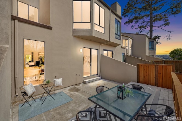 112 S Lake Merced Hls, San Francisco, CA 94132 - back of house at dusk featuring stucco siding, a patio, and outdoor dining space